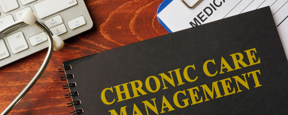 Chronic care management book on desk with keyboard