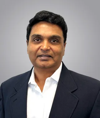 headshot photo of a man in a dark blue suit