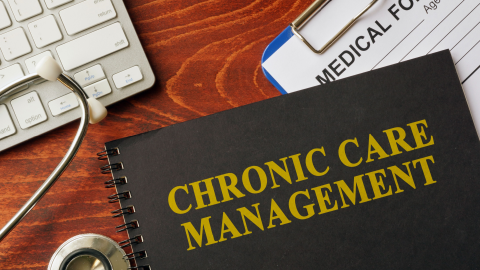 Chronic care management book on desk with keyboard