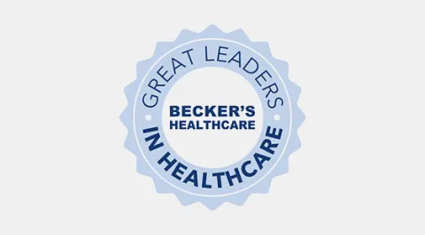 a light blue badge with the words "Great Leaders in Healthcare" around the words "Becker's Healthcare"