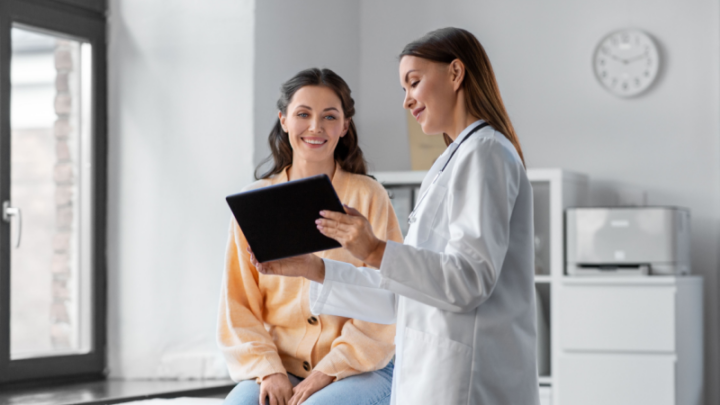 physician using referral management with patient